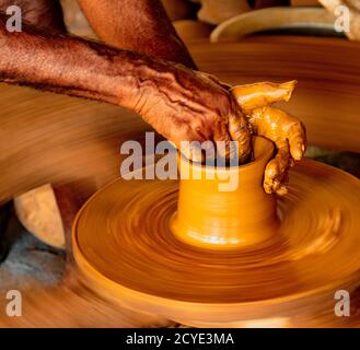 Madurai, India, Mar 10, 2018 - Man forms bowl on a manual pottery wheel with no electricity Stock Photo