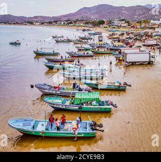 Puerto Lopez, Ecuador - September 12, 2018 - drone aerial view of beach with fishing boats on the sand at the end of the work day Stock Photo