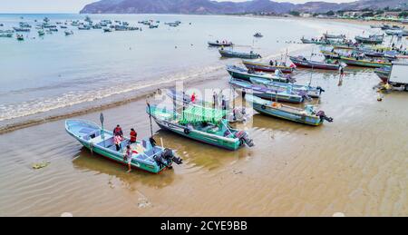 Puerto Lopez, Ecuador - September 12, 2018 - drone aerial view of beach with fishing boats on the sand at the end of the work day Stock Photo