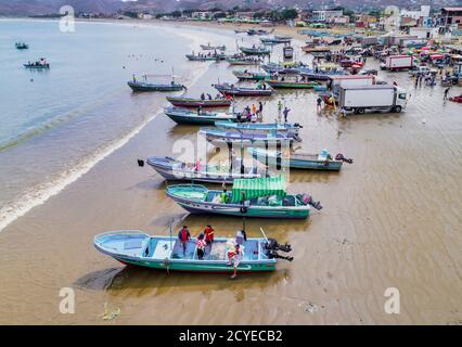 Puerto Lopez, Ecuador - September 12, 2018 - drone aerial view of beach with fishing boats on the sand at the end of the work day Stock Photo