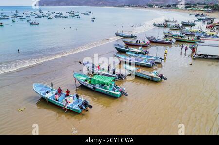 Puerto Lopez, Ecuador - September 12, 2018 - drone aerial view of beach with fishing boats on the sand at the end of the work day Stock Photo