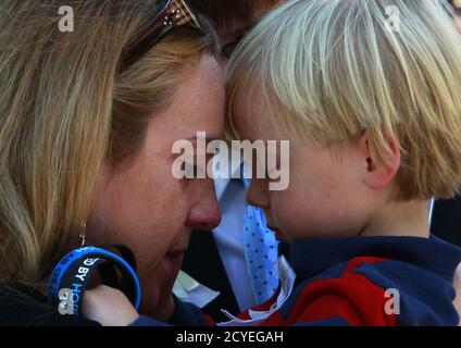 A woman embraces a child at the site of the 9/11 Memorial during ceremonies marking the 11th anniversary of the 9/11 attacks on the World Trade Center in New York, September 11, 2012. REUTERS/Eric Thayer (UNITED STATES  - Tags: ANNIVERSARY DISASTER)