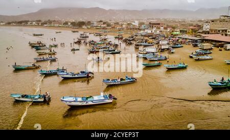 Puerto Lopez, Ecuador - September 12, 2018 - drone aerial view of beach with fishing boats on the sand at the end of the work day Stock Photo