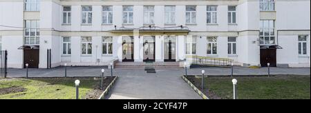 School building with an empty courtyard. Classic light plastered school house in Moscow, a typical building for educational institutions in the 30-50s Stock Photo