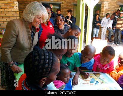 Camilla, Britain's Duchess of Cornwall, speaks to children at  a library in Cape Town's Masiphumelele township, November 5, 2011. Britain's Prince Charles and his wife, Camilla are in South Africa on a five-day visit. REUTERS/Mike Hutchings (SOUTH AFRICA - Tags: POLITICS ROYALS ENTERTAINMENT)