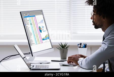 Analyst Employee Working With Spreadsheet On Computer Stock Photo