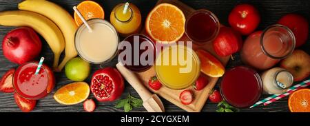Glasses and jars with different juices on wooden background Stock Photo
