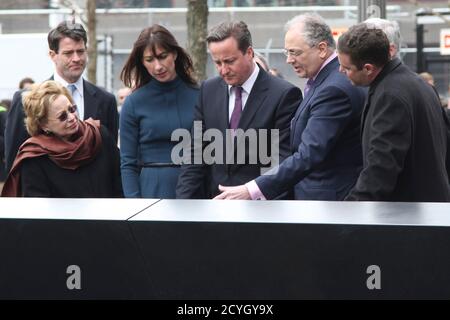 British Prime Minister David Cameron (C), and his wife Samantha (3rd L) pay their respects to Katherine Wolf alongside her husband Charles (2nd R), during a visit to the National September 11 Memorial in New York, NY, March 15, 2012.   REUTERS/Mary Altaffer/Pool   (UNITED STATES)