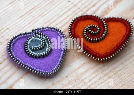 Valentine's day, handmade products from felt , two hearts of felt are on the board Stock Photo