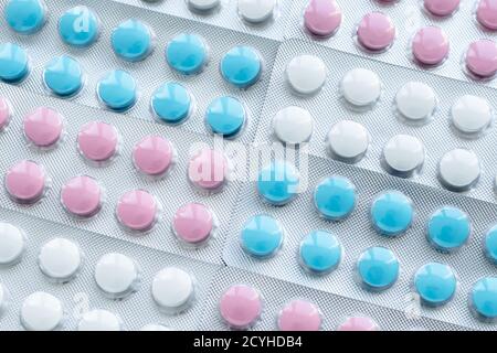 Abstract texture of blisters of multicolored round pills. Various diseases treatment concept. Medicines background, antibiotics sample Stock Photo
