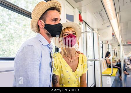 Beautiful couple driving on a subway wagon during covid-19 pandemic, concepts about lifestyle, trasportation and social distancing Stock Photo