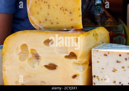 Different kinds of cheese for sale in market Stock Photo