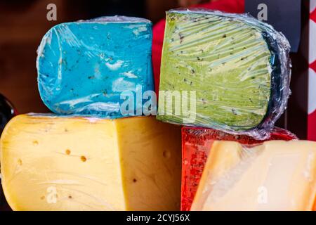Different kinds of cheese for sale in market Stock Photo