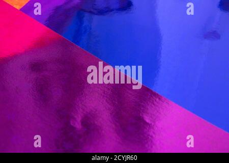 Blurred multicolor trendy backdrop. Bright holographic foil background. Colorful blue, red, purple background. Flat lay Stock Photo