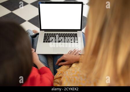 Mother and daughter using laptop at home Stock Photo