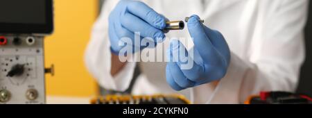 Master is holding bat and screwdriver lies next to hard drive Stock Photo