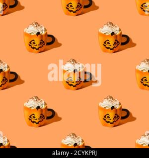 Seamless pattern of Halloween pumpkin coffee latte with wripped cream in fun cups on orange background. Stock Photo