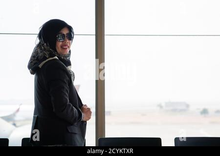 the silhouette of the rear view of a veiled Muslim woman standing in ...