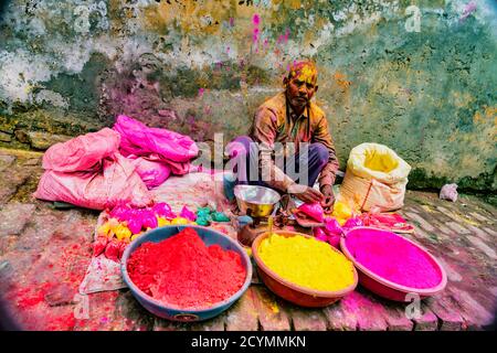 Barsana, India - February 23, 2018 - A man sells paint powder to be thrown by revelers during Holi festival Stock Photo