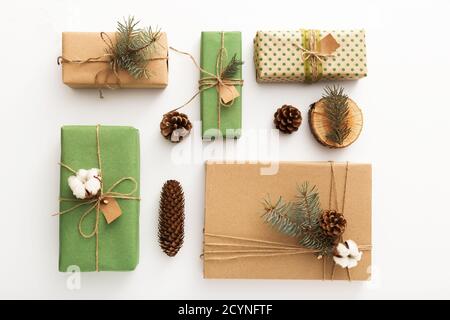Zero waste Christmas composition background made of pine cones, branches, candle, tree rings, crafted gifts with no plastic on white table. Top view Stock Photo