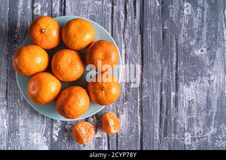 Fresh oranges on gray concrete background, flat lay, copy space. Stock Photo