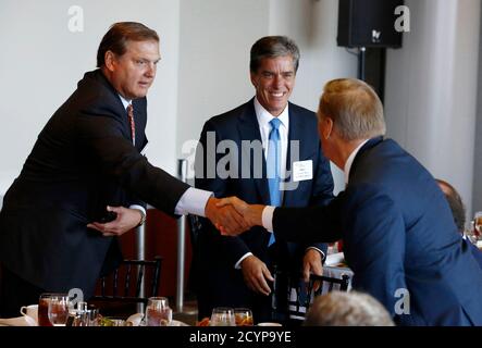 Eric Spiegel, CEO of Siemens Corp (L) is pictured alongside Shell Oil President Marvin Odum (C) at a business roundtable meeting of company leaders and U.S. Republican Presidential candidate Mitt Romney in Washington, June 13, 2012.  The man at right is unidentified.     REUTERS/Jason Reed   (UNITED STATES - Tags: POLITICS BUSINESS)