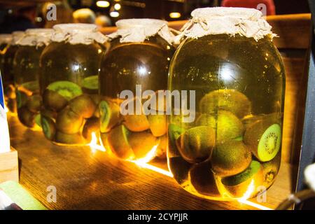 Canned fruit. Pickled or pickled canned capers fruit close up in glass jars on a wooden background Stock Photo