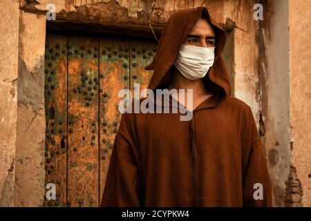 Berber Moroccan man wearing protective mask and Djellaba. Stock Photo