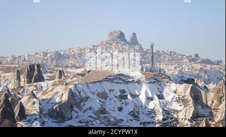 Snowy Cappadocia fairy chimneys rock formations during winter near Göreme, Turkey. Stock Photo