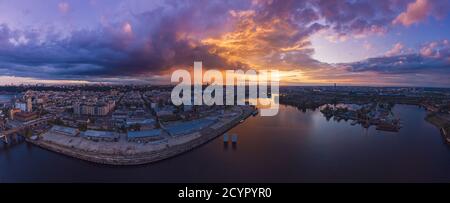 Dramatic colorful sunset over Dnipro river in Kiev, Ukraine, travel background. Big panorama from drone Stock Photo