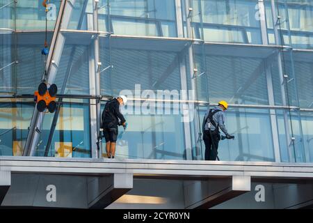 Mounting glass panes as cladding for an office building Stock Photo
