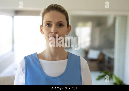 Portrait of Caucasian female nurse, looking at the camera and smiling. Medical care  at home during Covid 19 Coronavirus quarantine. Stock Photo
