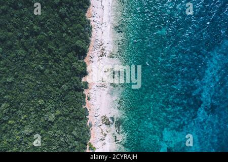 Creative minimal beach concept. Summer vacation layout with blue water and sand on bright background. Flat lay. Stock Photo