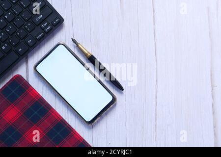 top view of smart phone and notepad on table  Stock Photo