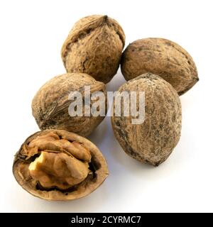 whole and peeled walnut kernels on a white background Stock Photo