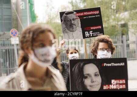 Berlin, Germany. 02nd Oct, 2020. Activists of 'Reporters Without Borders' stand at a vigil in front of the Saudi Arabian Embassy to commemorate the second anniversary of the murder of the Saudi Arabian exile journalist Jamal Khashoggi (pictured on the poster behind). Credit: Jörg Carstensen/dpa/Alamy Live News Stock Photo