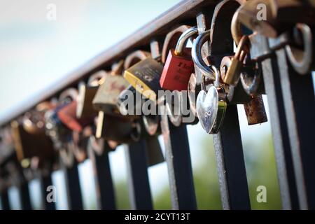 Love padlocks attached to the railing in Warsaw, Poland Stock Photo