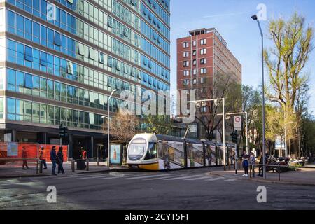 typical street of the productive center of the city with its grandiose buildings and the passing tram Stock Photo