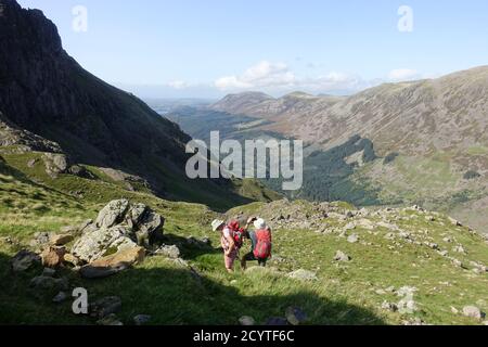 Hill walkers walking up Pillar looking down the Ennerdale valley Stock Photo