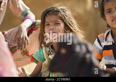 (Selective focus) Portrait of a beautiful young girl playing in a village in Jaisalmer, Rajasthan, India. Stock Photo