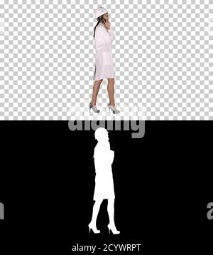 Female science engineer making a call while walking, Alpha Chann Stock Photo