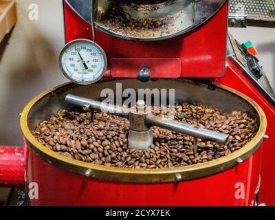 boquete, Panama, Dec 3, 2017 - Coffee beans are stirred by machine as they are being cooked in preparation for bagging Stock Photo