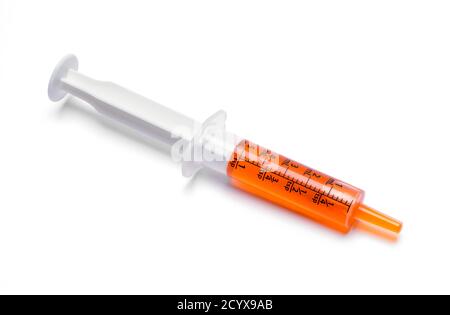 Oral Syringe With Orange Cough Medicine Dose. Stock Photo