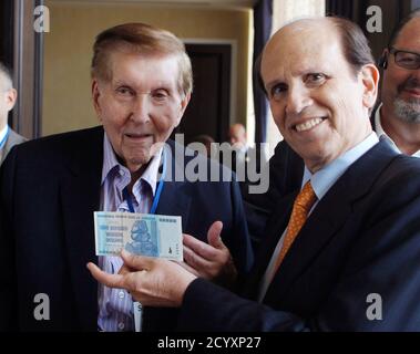 Sumner Redstone, executive chairman of Viacom Inc and CBS Corp, and Michael Milken (R), chairman of the Milken Institute, pose with a one hundred trillion dollars banknote from the Reserve Bank of Zimbabwe after a lunch session titled 'What It Means to Be an Entrepreneur: A Conversation With Sumner Redstone' at the Milken Institute Global Conference in Beverly Hills, California May 2, 2012. REUTERS/Danny Moloshok (UNITED STATES - Tags: BUSINESS MEDIA SOCIETY)