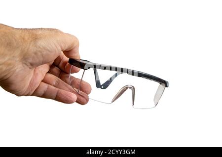Safety glasses for work in black plastic frames against white background Stock Photo