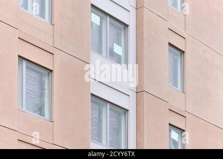 The modern pink facade of the apartment building in Finland. The modern nordic architecture. The building is under construction. Stock Photo
