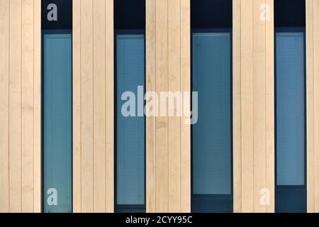The wooden facade with vertical windows of the modern office building. The modern nordic wooden architecture. Stock Photo