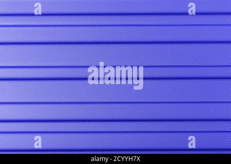 Classic blue color 2020. Texture of striped plastic, metal hi-tech raw future lightweight material. Classic blue background, blue toning. Abstract tre Stock Photo