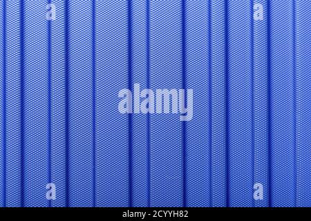 Classic blue color 2020. Texture of striped plastic, metal hi-tech raw future lightweight material. Classic blue background, blue toning. Abstract tre Stock Photo