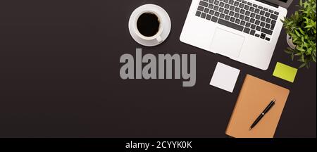 Workspace with laptop, office supplies. Stylish table desk, image with copy space on black background Stock Photo